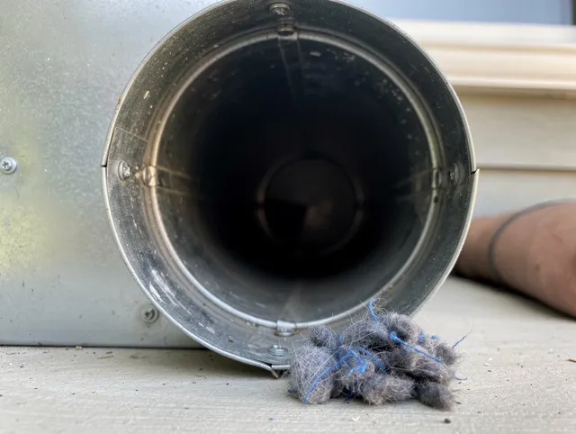Huntersville Dryer Vent Cleaning technician using specialized equipment to clear severe dryer vent blockage in Huntersville